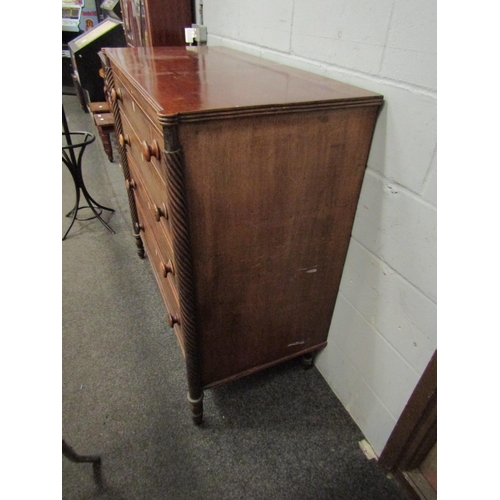 1046 - A 19th Century mahogany chest of four long drawers, satinwood stringing, turned bun handles, bone es... 