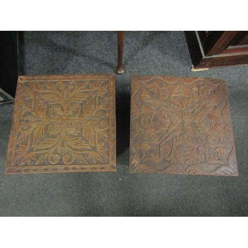 1057 - A pair of small carved oak coffee tables, both with foliate design, dated 1944 to underside, one mar... 