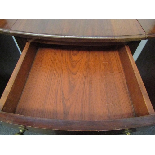 1073 - A mahogany Pembroke table with single end drawer and under-tier, tapering legs to castors  (E)  £15-... 