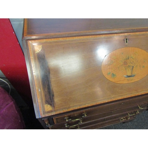 1077 - A 19th Century mahogany bureau, the front with oval marquetry panel, over four drawers, satinwood cr... 