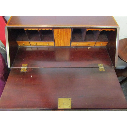 1077 - A 19th Century mahogany bureau, the front with oval marquetry panel, over four drawers, satinwood cr... 