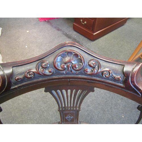 1098 - An Edwardian mahogany corner chair, scrolled foliate carved back rest over pierced splats, upholster... 