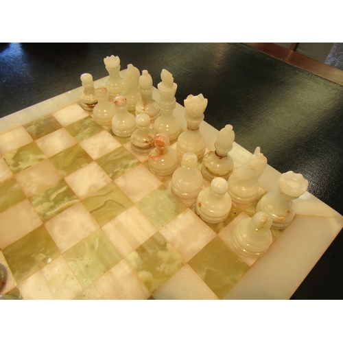 1101 - A marble chess board with onyx pieces, cased