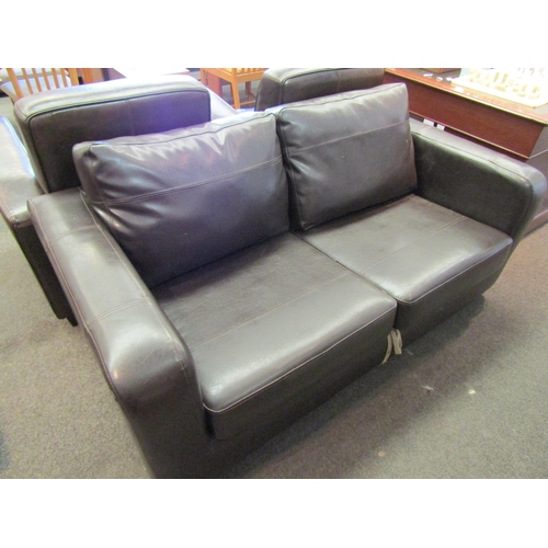 1104 - A modern leather two seater sofa bed