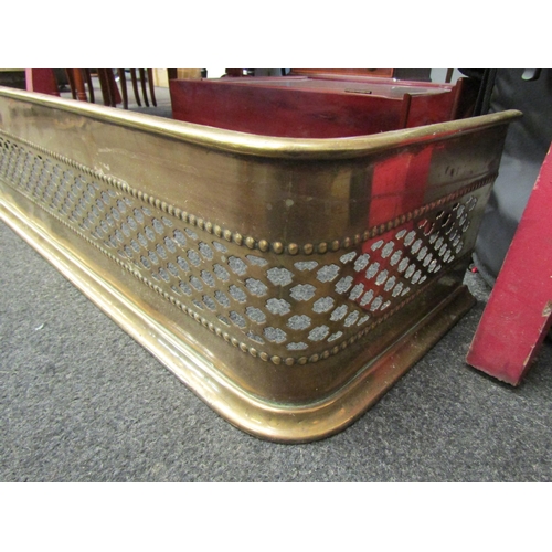 1130 - A pierced brass fire fender with curved corners, 129cm long x 30cm deep