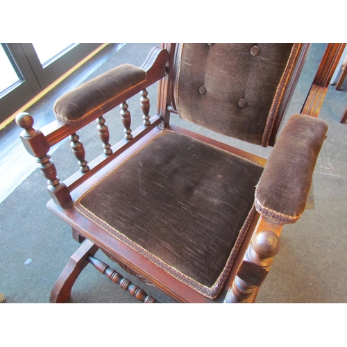 1009 - An American style button back rocking chair with turned spindle supports