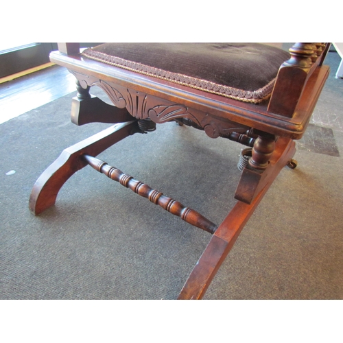 1009 - An American style button back rocking chair with turned spindle supports