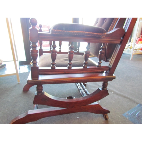 1009 - An American style button back rocking chair with turned spindle supports