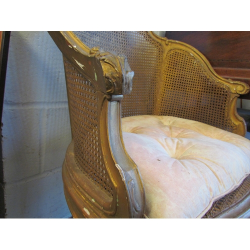 1019 - A giltwood bergere tub chair on cabriole fore legs with carved detailing