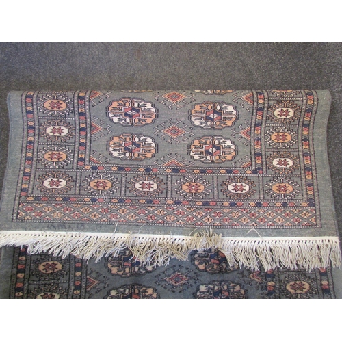 1025 - A geometric runner rug, green ground, tasselled ends, 247cm x 81cm