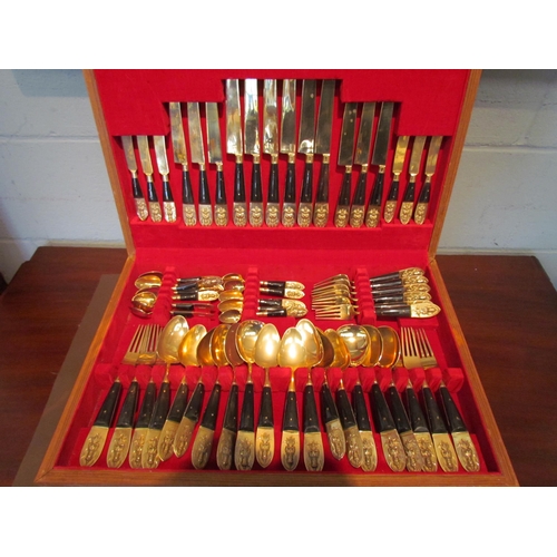 1094 - A canteen of brass cutlery, finials embossed with Indian figures