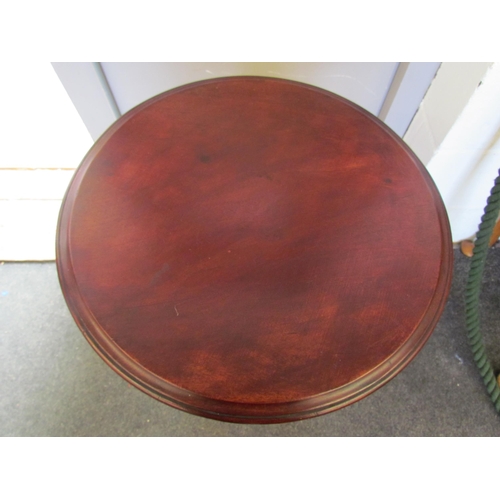 1103 - A 19th Century mahogany circular top lamp table on a turned and fluted column with carved leaf circu... 