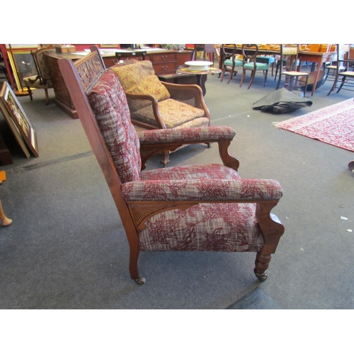 1104 - An Arts & Crafts mahogany armchair with carved decoration on turned fore legs and ceramic castors