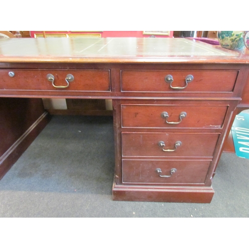 1111 - A Norfolk Manor twin pedestal mahogany desk, seven drawers, gilt tooled green leather insert, 77cm h... 