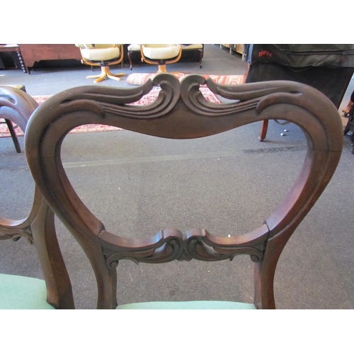 1152 - Four carved mahogany dining chairs with sabre back legs and fluted turned front legs          (E) £1... 