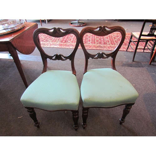 1152 - Four carved mahogany dining chairs with sabre back legs and fluted turned front legs          (E) £1... 