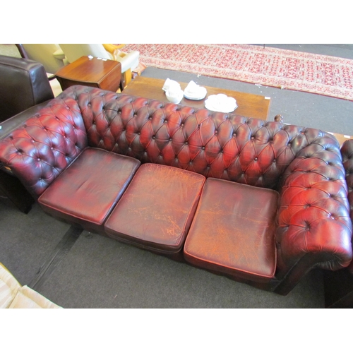 1165 - A red leather Chesterfield three seater sofa