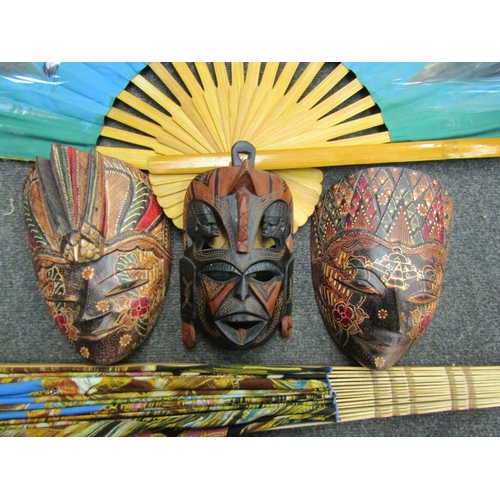 1174 - An oversized Bali style fan with another similar example and three balsa wood masks (5)