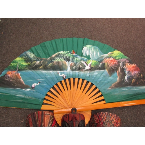 1174 - An oversized Bali style fan with another similar example and three balsa wood masks (5)