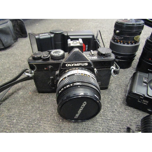 1186 - A box of vintage cameras and accessories including Canon camera, Olympus camera and cased lens