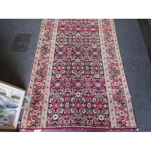 1156 - An Eastern wool hall runner rug, red and cream ground with foliate motifs, formerly from Holkham Hal... 