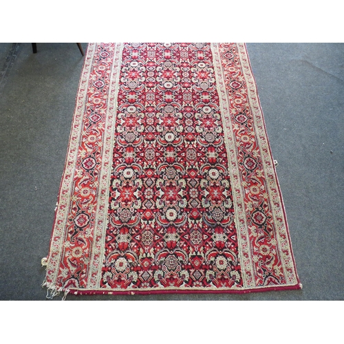 1156 - An Eastern wool hall runner rug, red and cream ground with foliate motifs, formerly from Holkham Hal... 