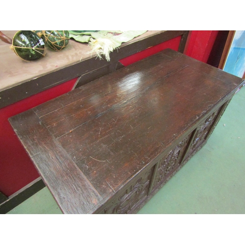 4003 - An 18th Century oak coffer, carved front panels on bun feet, 63cm high x 106cm wide x 53cm deep