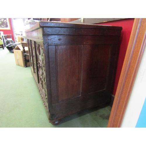 4003 - An 18th Century oak coffer, carved front panels on bun feet, 63cm high x 106cm wide x 53cm deep