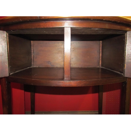 4061 - A Georgian mahogany bow front side table the three quarter raised back over a two door cupboard on s... 