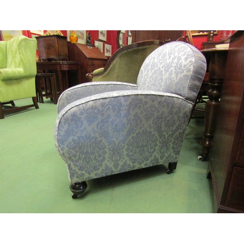 4116 - A circa 1920 lady's club armchair on turned oak fore feet and castors   (R) £50 FIRM