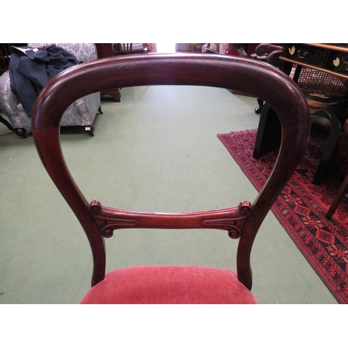 4124 - An early Victorian rosewood balloon-back chair on turned and tapering fore legs