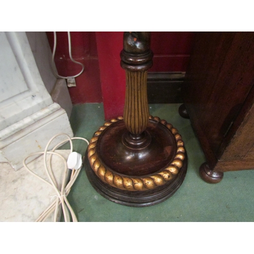 4174 - An oak barley twist and fluted standard lamp with gilt relief on a dragoon carved circular base