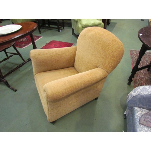 4192 - A circa 1920 club armchair the rounded backrest over scroll arms on turned feet and castors   (R) £6... 