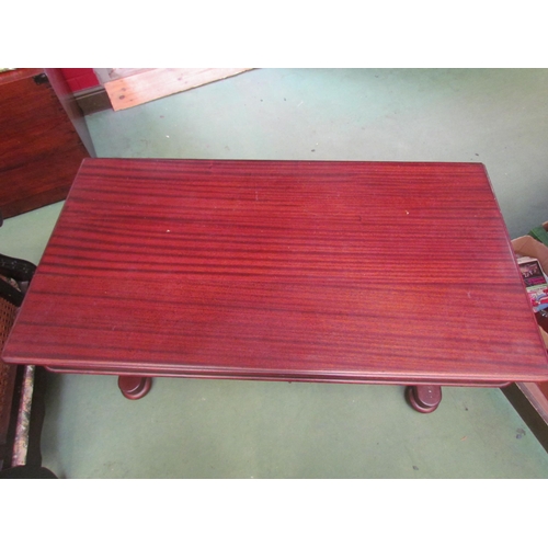 4194 - A mahogany sofa table on carved supports to stretcher base on bun feet, 72cm high x 110cm wide x 58c... 