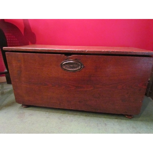 4216 - A 19th Century elm chest of small proportions, the hinged lid and paper lined interior over turned f... 