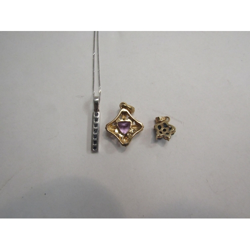 4370 - A 9ct gold amethyst pendant, a 9ct gold sapphire flower form pendant and a 9ct white gold sapphire p... 