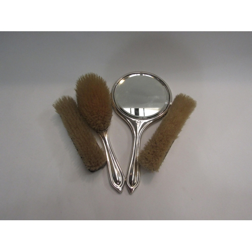 4400 - A silver four piece tortoiseshell and silver dressing set including hand mirror and brushes, ribbon ... 