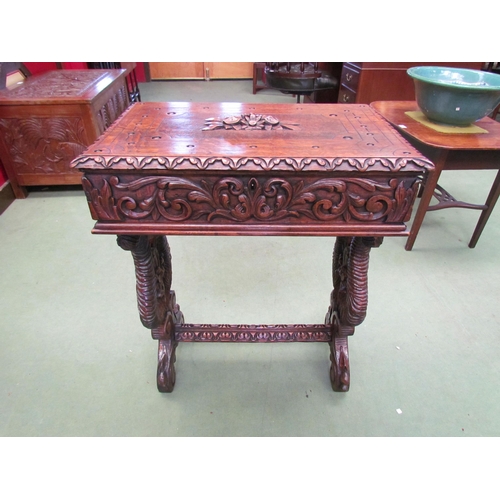 4008 - A Victorian carved oak worktable in the manner of the 'Black Forest' region, the hinged top over a s... 