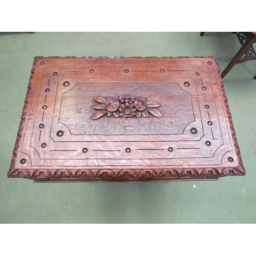 4008 - A Victorian carved oak worktable in the manner of the 'Black Forest' region, the hinged top over a s... 