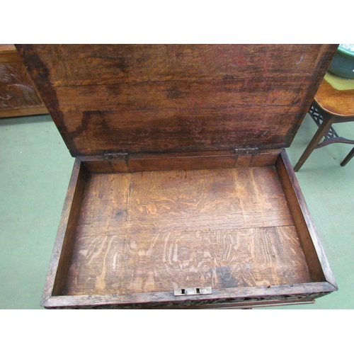 4008 - A Victorian carved oak worktable in the manner of the 'Black Forest' region, the hinged top over a s... 