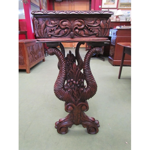 4008 - A Victorian carved oak worktable in the manner of the 'Black Forest' region, the hinged top over a s... 