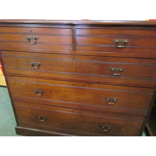 4030 - A Circa 1900 walnut chest of two short over three graduating long drawers with reeded decoration and... 