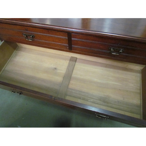 4030 - A Circa 1900 walnut chest of two short over three graduating long drawers with reeded decoration and... 