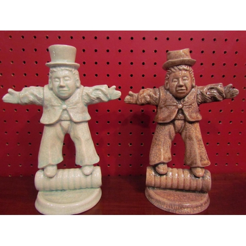 4047 - A pair of Studio pottery glazed candle holders in the form of men log rolling, 19.5cm tall