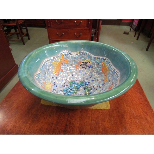 4081 - A large ceramic bowl, the interior decorated with mosaic fish design, 19.5cm tall x 47cm diameter   ... 