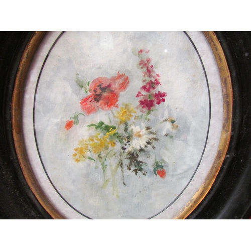 4127 - Two floral oils on board. Ebonised oval frames. 22cm x 17cm image sizes