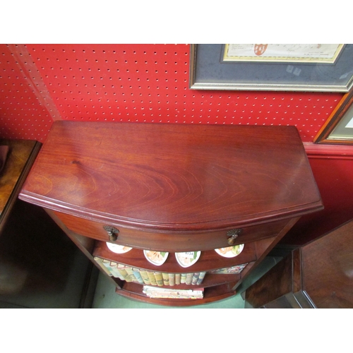 4136 - An Edwardian mahogany bow front dwarf bookshelf the single frieze drawer over three shelves on a bra... 