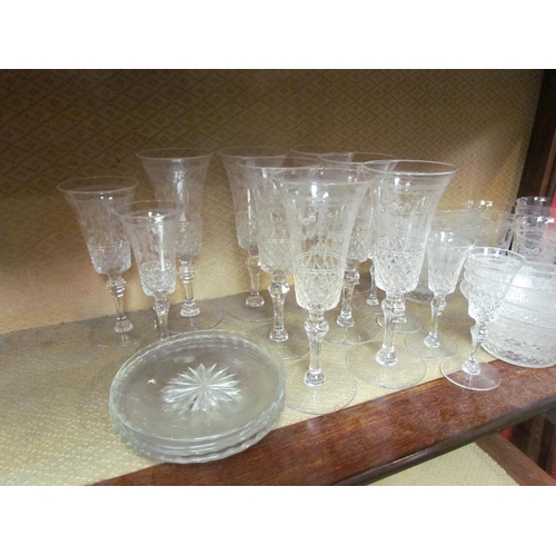 4149 - A part suite of Edwardian table glass, part cut, part swag decoration: champagne flutes, water tumbl... 