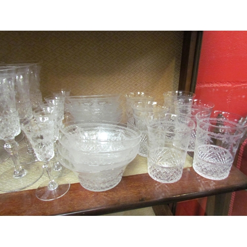 4149 - A part suite of Edwardian table glass, part cut, part swag decoration: champagne flutes, water tumbl... 