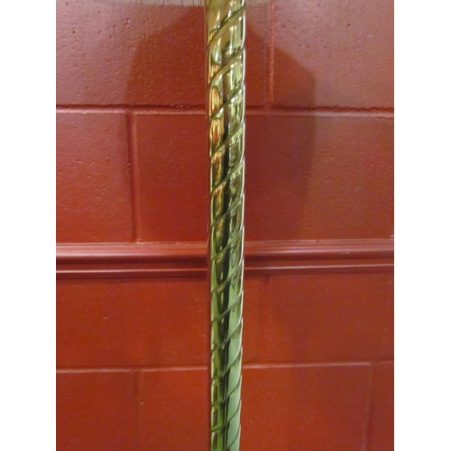 4179 - A standard lamp, brass effect spiral column, fringed shade